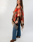 Side view of Fireside Plaid Shawl featuring warm orange and beige tones, ideal for stylish fall layering with casual outfits.