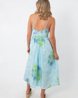 Back view of Allium Field Floral Embroidered Midi Dress with floral print, spaghetti straps, and flowing hemline, styled with platform sandals