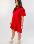 Side view of Eloise Red Crepe Button Mini Dress showcasing flutter sleeves and relaxed fit, ideal for Christmas and party season wear.