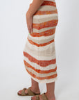 Full-length view of knit midi skirt with sunset stripe pattern, beige and orange, summer beachwear