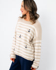 Side view of Anchors Away Taupe Stripe Sweater with anchor embroidery and beige-white horizontal stripes, styled for a laid-back nautical look.