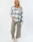 Model wearing Rosemary Utility Wide Leg Jeans – Faded Green High Rise Denim, paired with a plaid shirt and cream boots for a fall outfit.