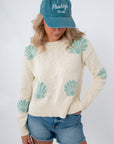 Coastal cream seashell print knit sweater with beach-inspired design
