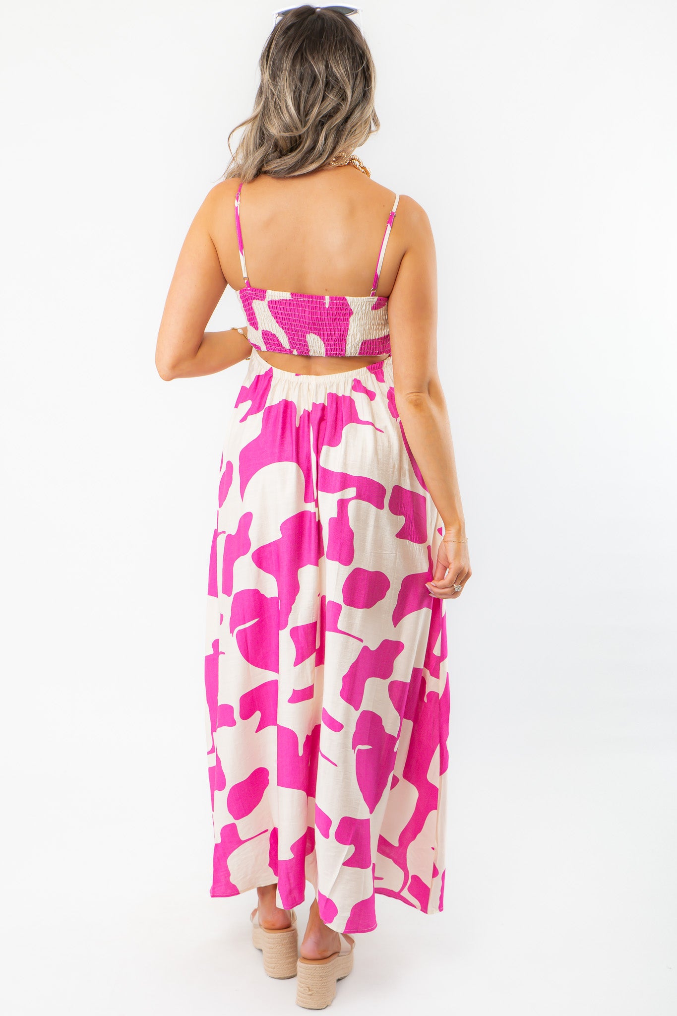 Back view of Meet Me in Santorini Fuchsia Wave Maxi Dress featuring smocked bodice and flowy silhouette in bold vacation-ready print.