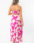 Back view of Meet Me in Santorini Fuchsia Wave Maxi Dress featuring smocked bodice and flowy silhouette in bold vacation-ready print.