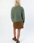 Back view of Dark Sage Ribbed Crewneck Sweater showing relaxed fit and ribbed texture, great for casual fall fashion.