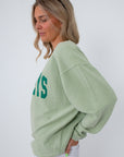 Back view of green Pawleys Island sweatshirt with logo and text detail