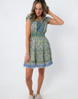 Side view of Alicia Lagoon Blockprint Sleeveless Mini Dress with floral print and pockets