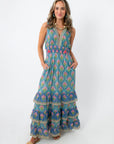 Side view of vibrant floral maxi dress with pockets and tiered hem