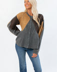 Steve Madden Argyle Lillie Cardigan in soft gray with brown and mustard argyle pattern, featuring a peplum hem and crewneck style.