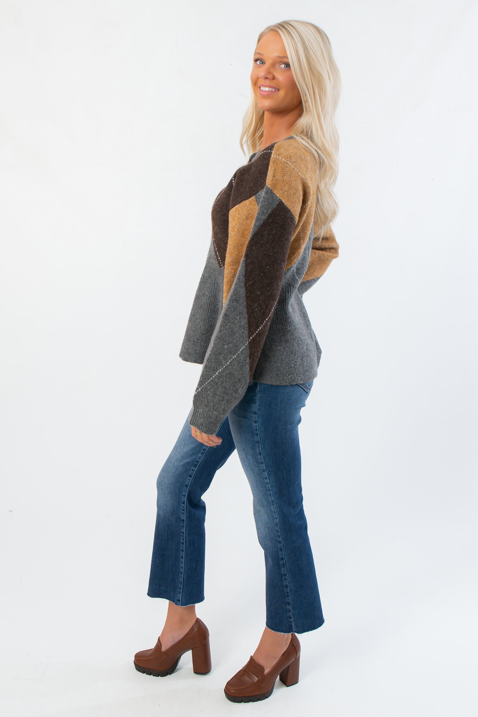 Side view of Steve Madden Argyle Lillie Cardigan showing peplum silhouette and color-blocked argyle sleeves in neutral tones.