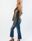Side view of Steve Madden Argyle Lillie Cardigan showing peplum silhouette and color-blocked argyle sleeves in neutral tones.
