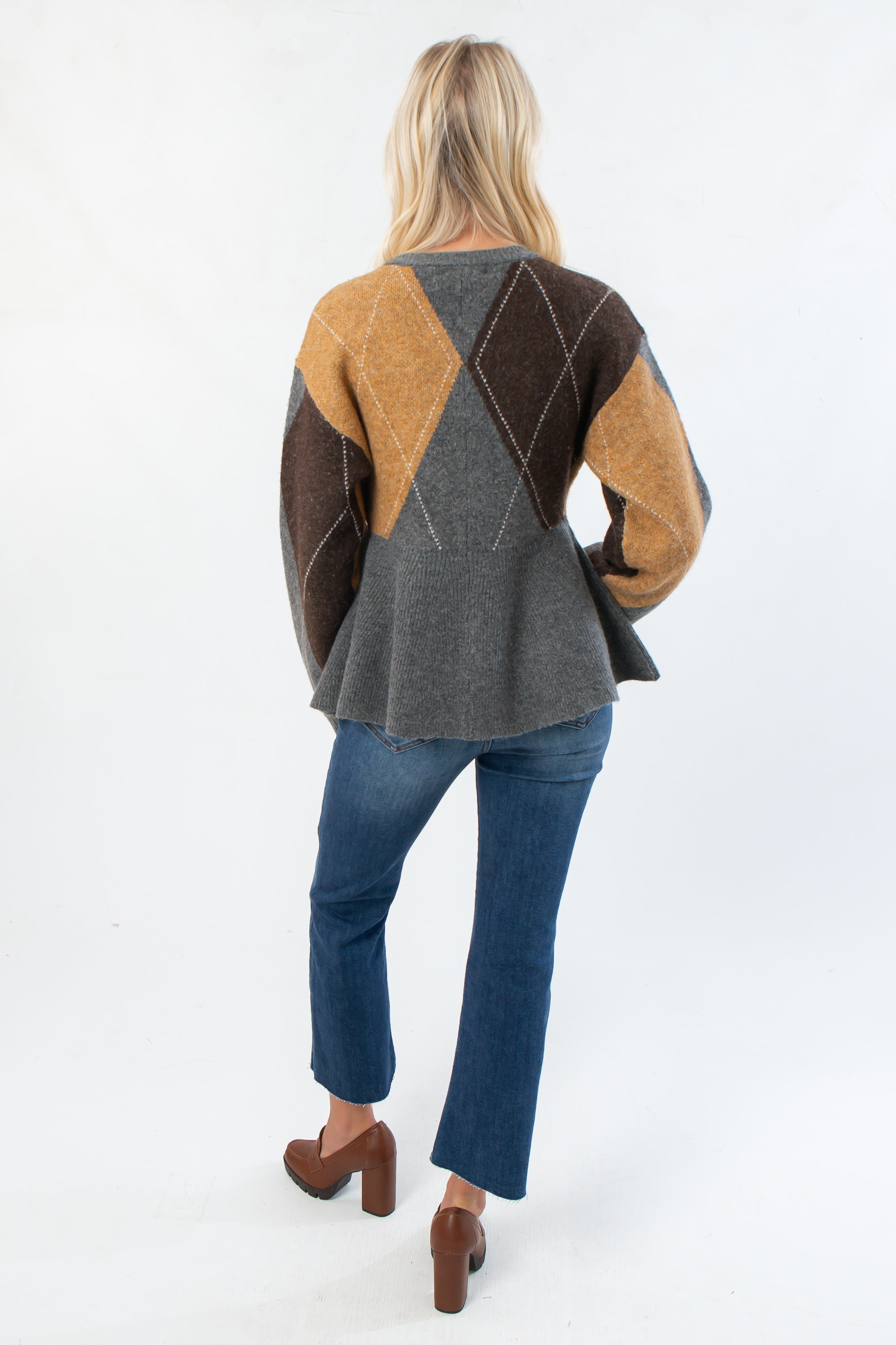 Back view of Steve Madden Argyle Lillie Cardigan highlighting flared peplum bottom and large argyle knit pattern on the back.