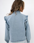 Back view of Ruffle-Trim Light Wash Denim Jacket with shoulder ruffles and light wash finish, a chic women’s outerwear piece for casual looks.