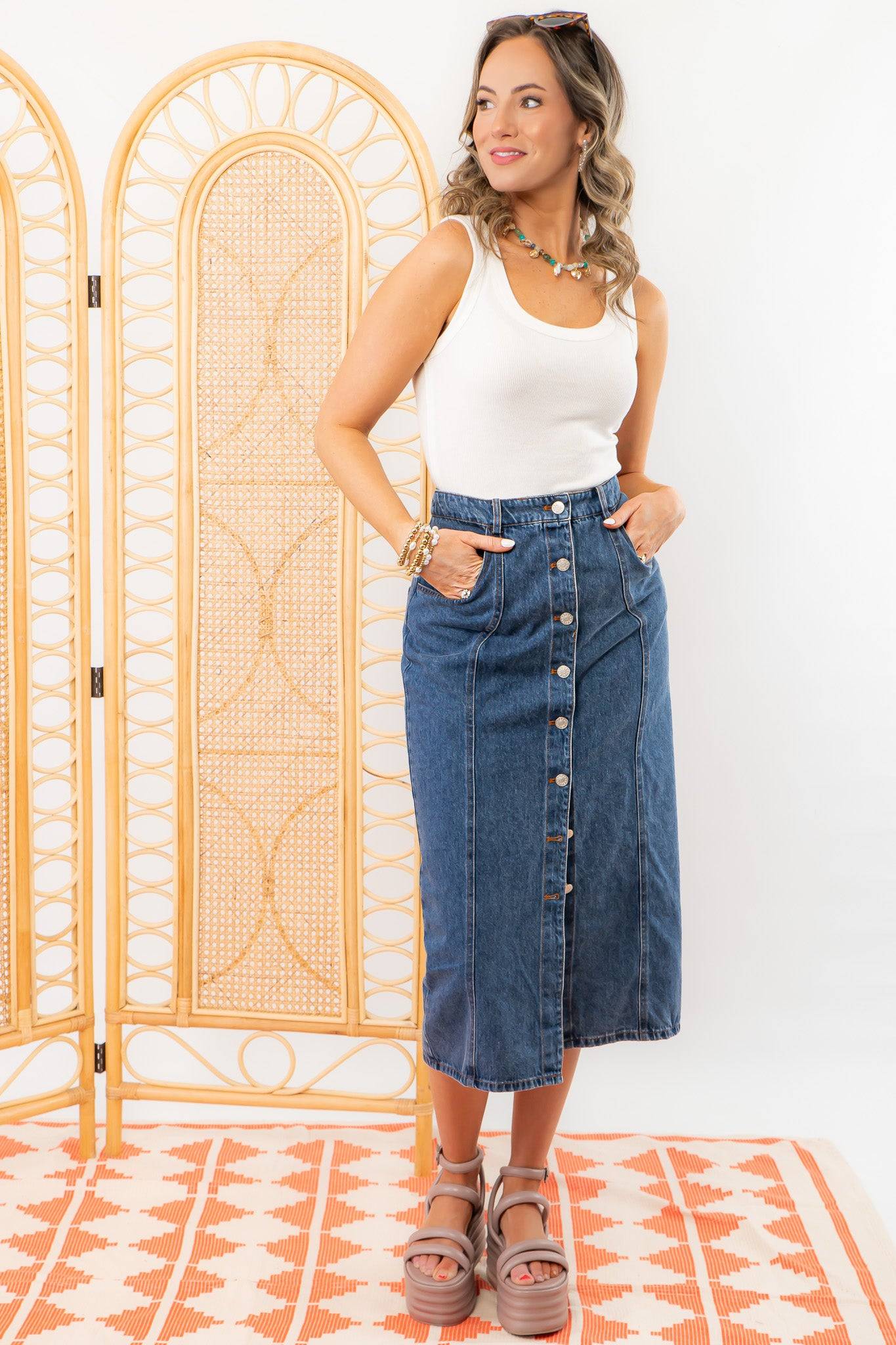 Model wearing Bethany Dark Wash Button Down Denim Skirt with hands in pockets, showcasing its casual and stylish appeal.