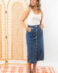 Model wearing Bethany Dark Wash Button Down Denim Skirt with hands in pockets, showcasing its casual and stylish appeal.