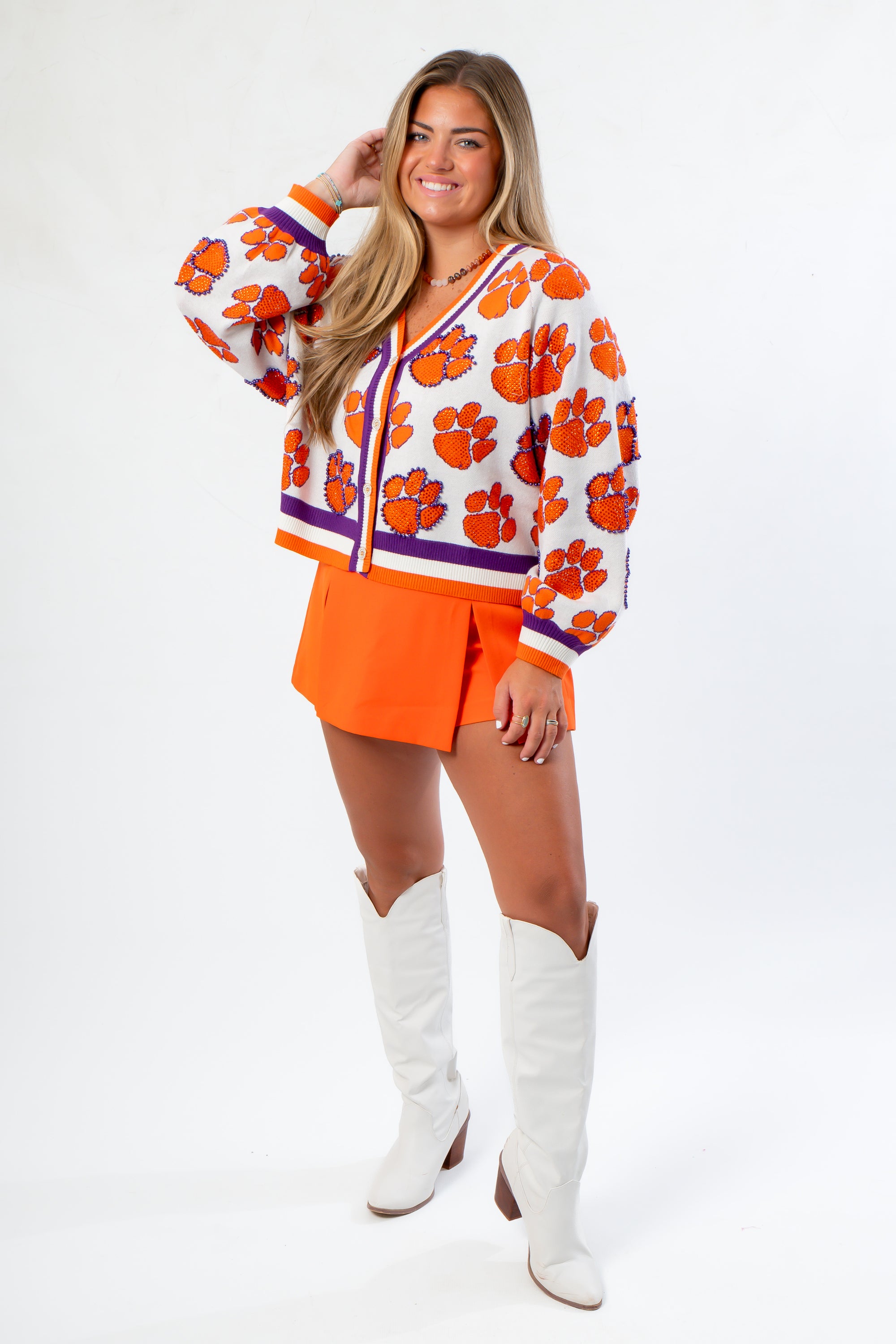 Queen of Sparkles Clemson Mascot Rhinestone Cardigan styled with orange skort and white boots, perfect for spirited game day looks.
