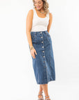 Model wearing Thick Strap Ribbed Off White Basic Tank with denim skirt and platform sandals, perfect for a relaxed summer outfit.
