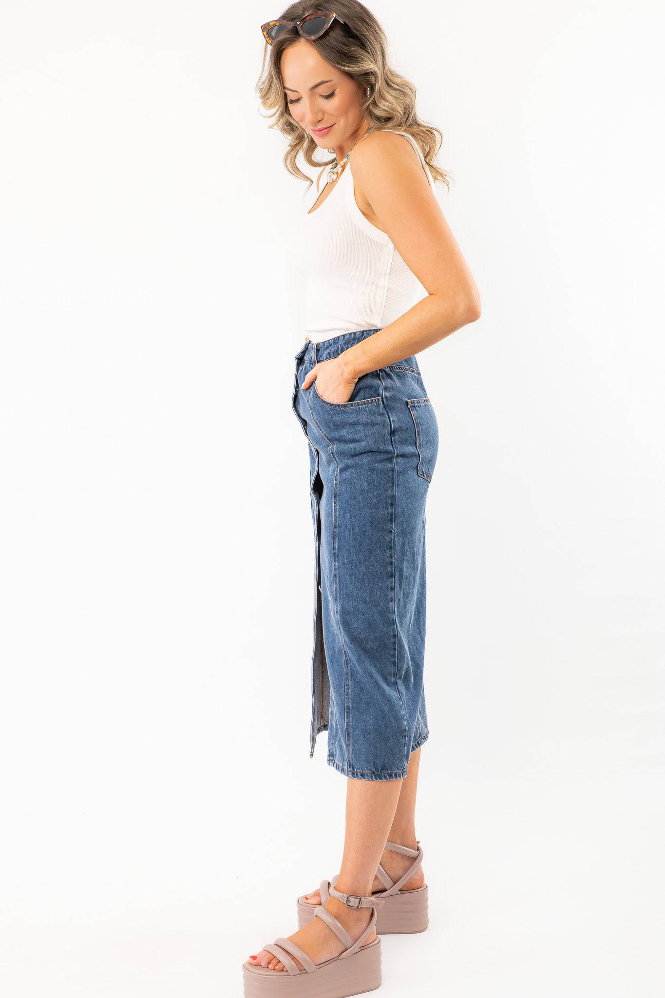 Side profile of Bethany Dark Wash Button Down Denim Skirt highlighting its midi length and slight stretch for easy movement.