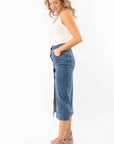 Side profile of Bethany Dark Wash Button Down Denim Skirt highlighting its midi length and slight stretch for easy movement.