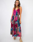 Tropical Jewel Satin Palm Print Maxi Dress in vibrant fuchsia with sleeveless design and belted waist, ideal for summer beach outings.