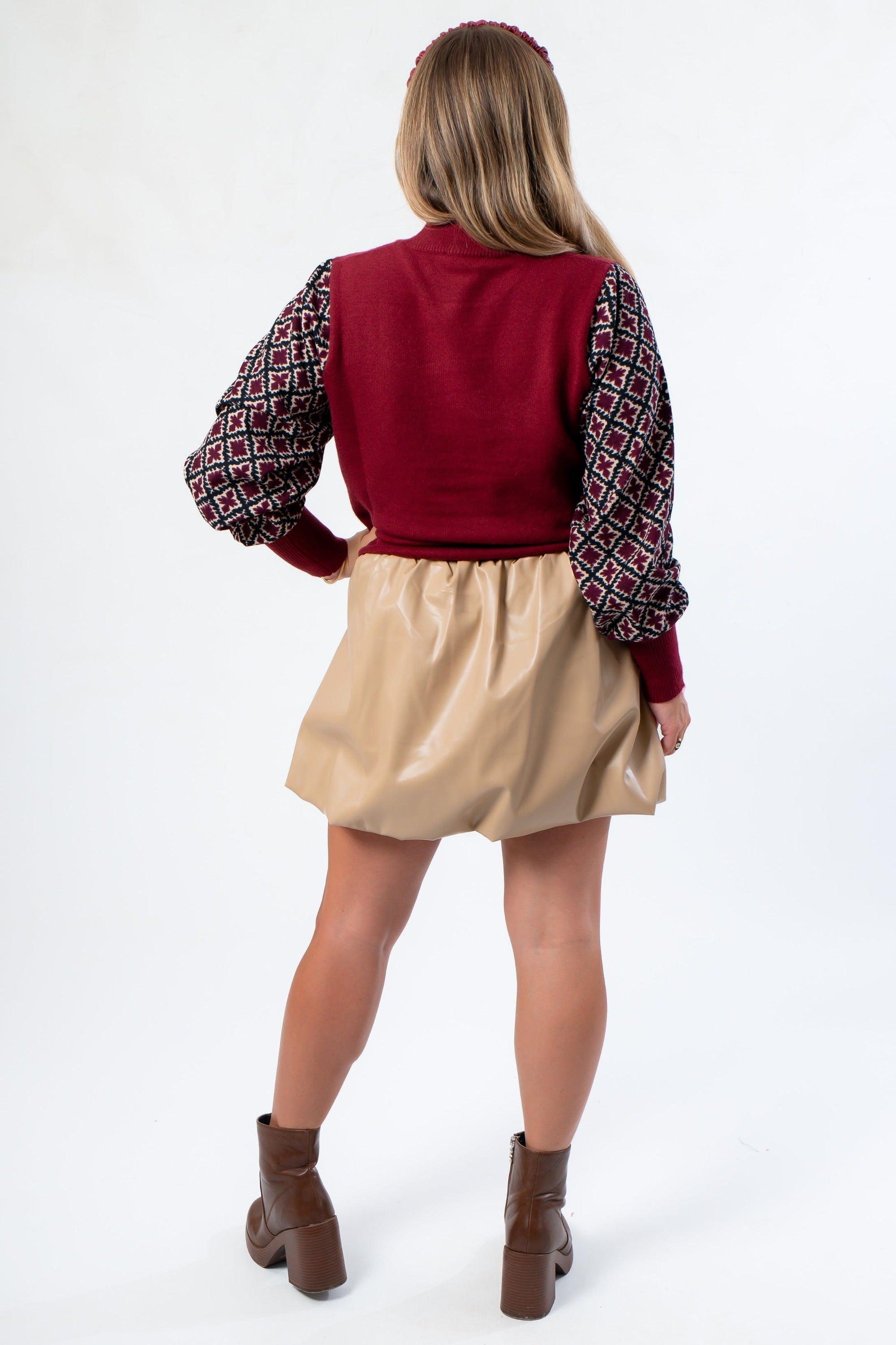 Back view of THML Mixed Media Garnet Top highlighting its solid knit back and patterned sleeves. A trendy and comfortable knitwear piece.