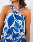 Close-up of the Santorini Skies Halter Dress showing the adjustable halter neckline with bold blue and white tropical pattern.