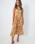 Side view of floral midi dress with pink and orange tulip print, featuring adjustable straps and a relaxed fit
