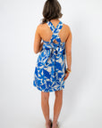 Back view of the Santorini Skies Halter Dress with crisscross straps and a tied bow detail, perfect for vacation styling.