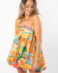 Show Me Your Mumu Postcards From Italia Bubble Dress featuring a strapless A-line silhouette with vibrant vacation-themed prints and bubble hem.