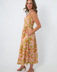 Back view of pink and orange tulip floral midi dress with adjustable straps and a gathered waist for spring events