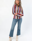 Supersoft Steve Madden Burgundy Serra Stripe Sweater featuring long sleeves and mixed stitching, paired with flared jeans and ankle boots.