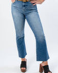Close-up of Medium Wash High Rise Crop Flare Jeans showcasing raw hemline and kick flare design. Ideal for casual and chic outfits.