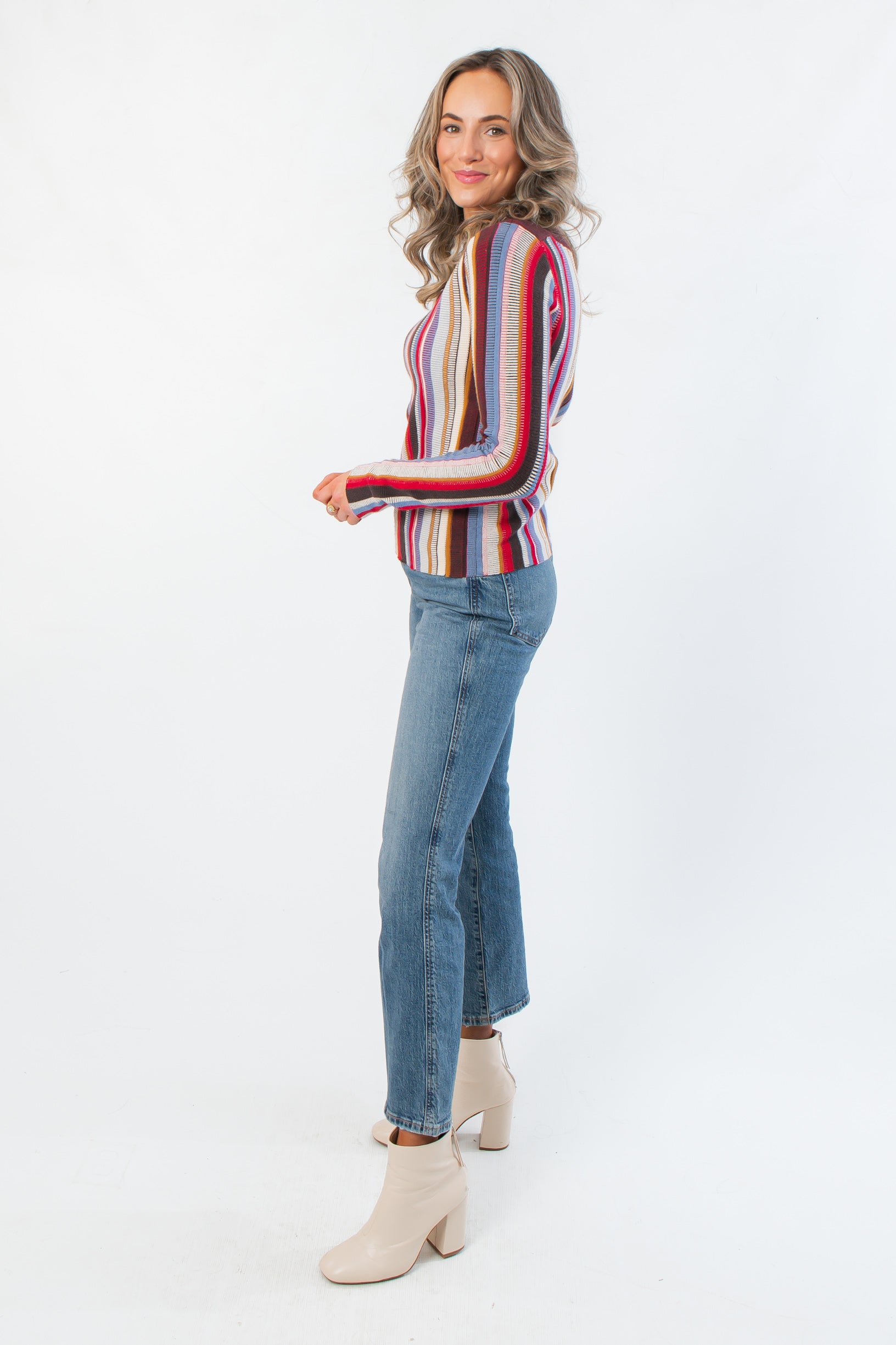 Side view of Steve Madden Burgundy Serra Stripe Sweater showing fitted silhouette and colorful knit pattern, ideal for layering in cool weather.