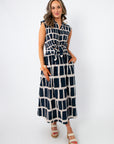 Newport Knot-Front Navy Midi Dress with keyhole tie waist and sleeveless design, styled for summer in a bold navy and white geometric print.