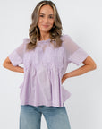 Front view of Lacy Lavender Mesh Babydoll Blouse featuring sheer mesh yoke and intricate lace accents, perfect for spring workwear.