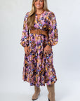 Jod Purple Print Maxi Dress featuring a flowy silhouette and floral multi-print, ideal for casual or gameday wear.