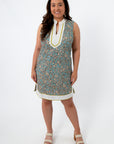 Front view of teal floral patterned THML Charleston Cane Contrast Trim Short Dress with white and yellow accents, model smiling