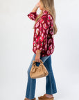 Side view of Animal Print Mock Neck Sweater - Fashionable Attire showcasing its loose silhouette and eye-catching print for everyday chic.