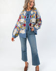 Front view of Apple A Day Blue Tie Front Cardigan featuring colorful apple pattern, long sleeves, and relaxed fit for stylish layering.
