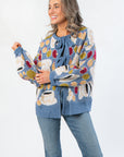 Apple A Day Blue Tie Front Cardigan with oversized apple print and front bow tie, styled with jeans for a cozy fall look.