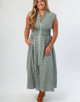Stylish Pre-Fall Patch Season Green Gingham Midi Dress featuring front zip closure, side pockets, and flattering smocked waist design.