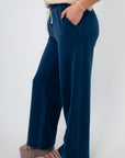 Side view of Z Supply Indigo Hunter Knit Denim Pant showing wide-leg silhouette and cozy knit texture in indigo blue for casual comfort.