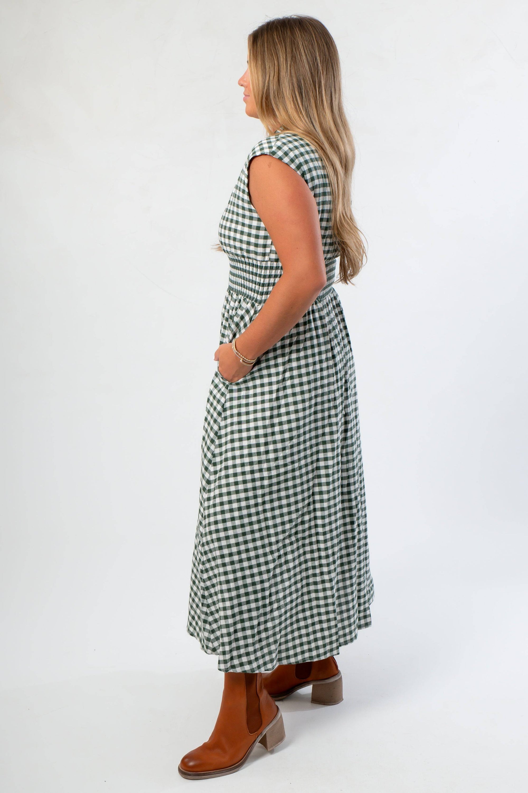 Side view of Patch Season Green Gingham Front Zip Midi Dress showing cap sleeves, smocked waist, and flowy skirt for casual fall outfits.