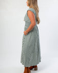 Side view of Patch Season Green Gingham Front Zip Midi Dress showing cap sleeves, smocked waist, and flowy skirt for casual fall outfits.