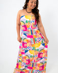 Side view of vibrant strapless maxi dress with tropical beach pattern and tie detail