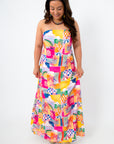 Front view of colorful abstract summer dress with strapless neckline and tropical print
