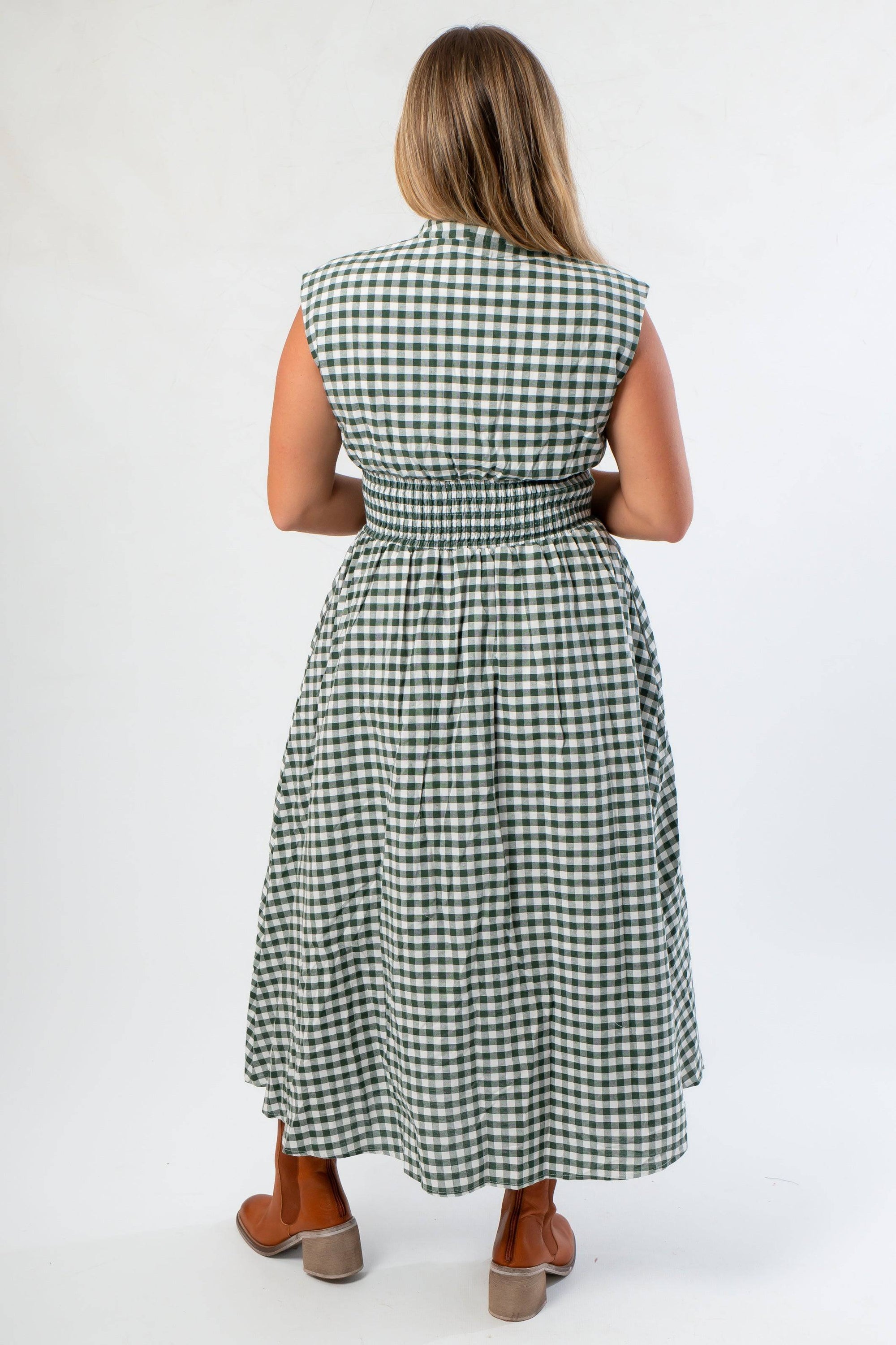Back view of Patch Season Green Gingham Midi Dress highlighting smocked waist and gingham pattern, ideal for pre-fall fashion styling.