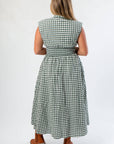 Back view of Patch Season Green Gingham Midi Dress highlighting smocked waist and gingham pattern, ideal for pre-fall fashion styling.