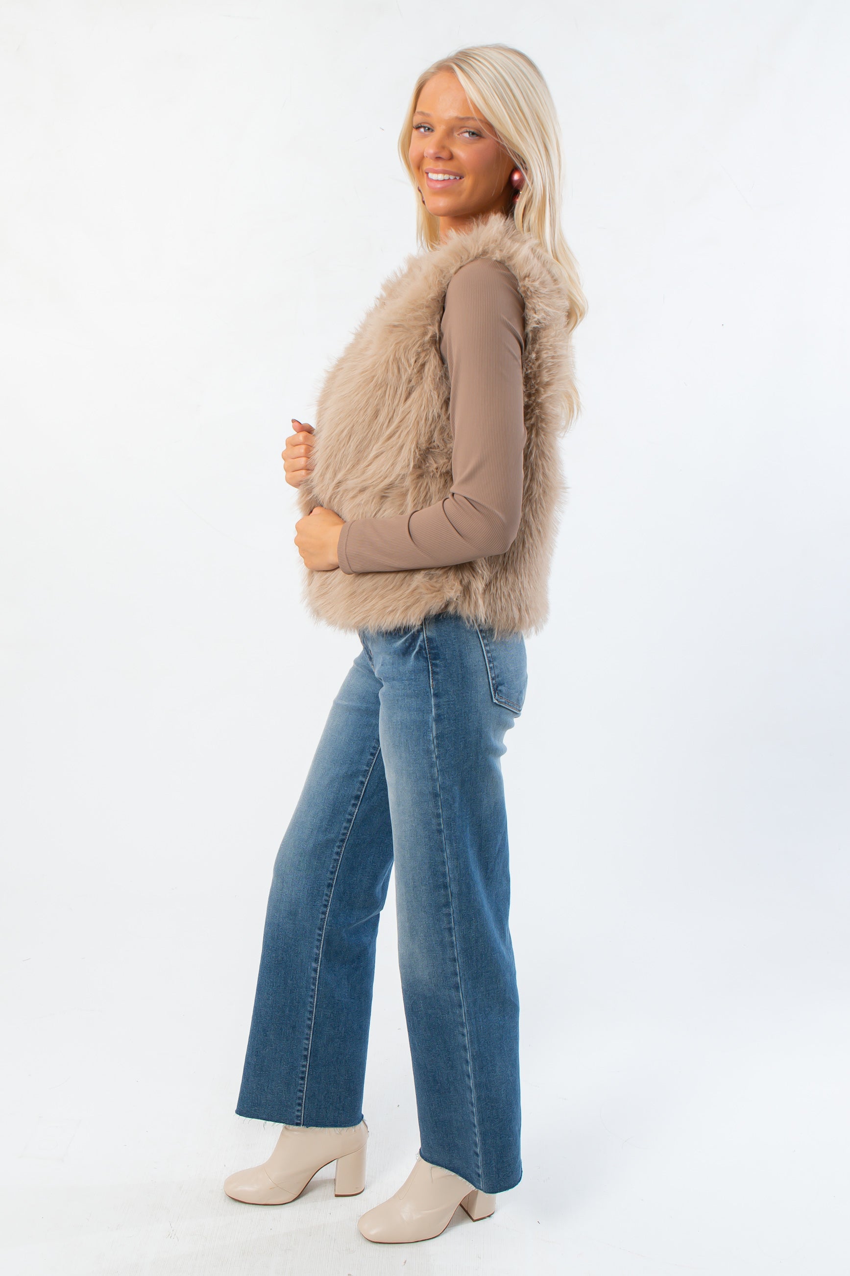 Side view of Fifth Avenue Taupe Faux Fur Vest showing soft faux fur texture and flattering fit. Stylish women’s vest for fall and Thanksgiving outfits.